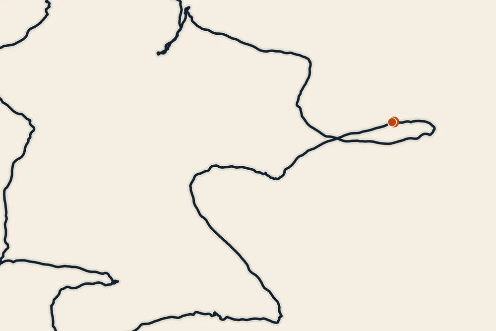 Close-up of a printed route: a dark ink line with a small orange dot marking the start
